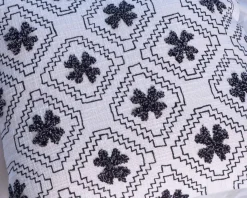Coussin décoratif en coton blanc avec motif brodés et pompons 
